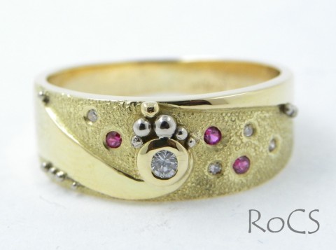 Textured, punch set diamond and ruby band image