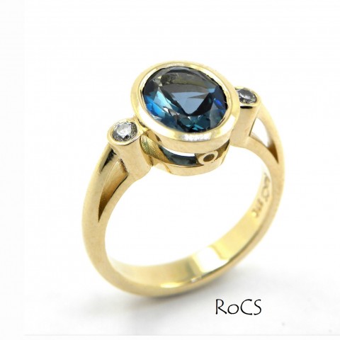 Blue topaz in rub setting with diamond accents image