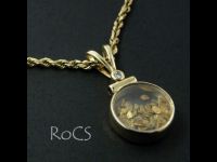 Gold pendant filled with gold flakes and set with diamond and sapphire image